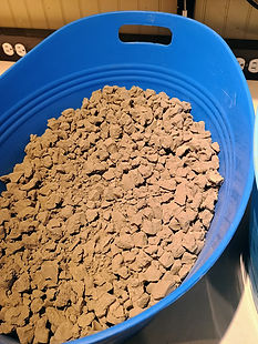 We break the bone dry clay into smaller pieces and store it