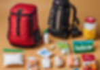 a first aid kit, backpack with emergency supplies, lantern, non -pershibke food items on a