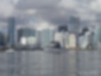 Trawler photo gallery: boat on water with city skyline.