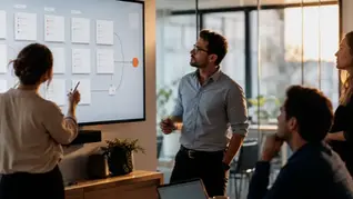 A team reviewing an automated sales-workflow board on a screen in a warm-lit office