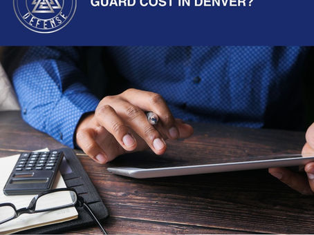 Person reviewing security guard costs on a tablet beside a calculator and notebook.