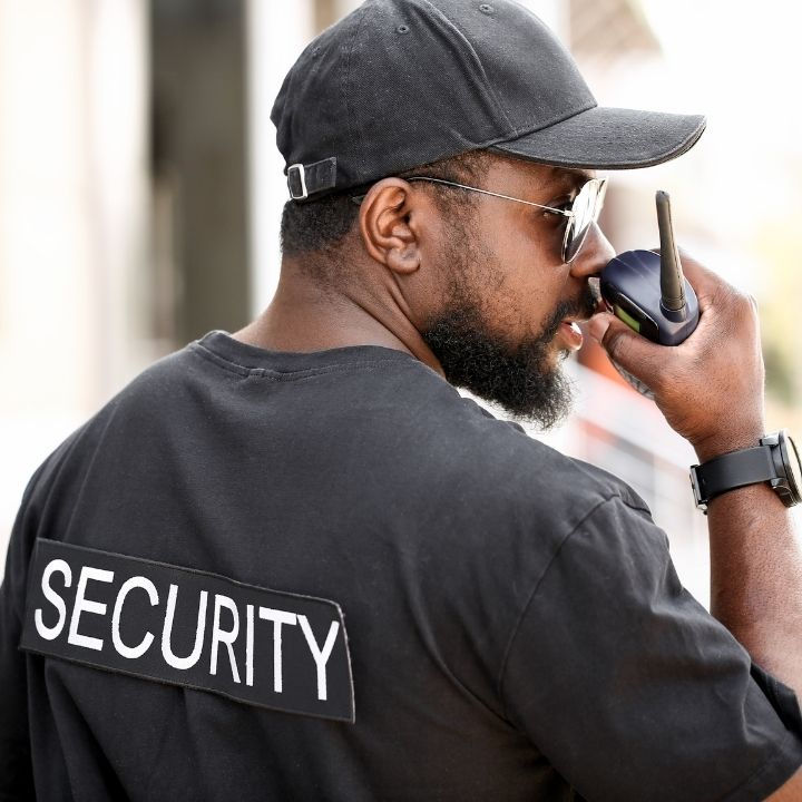 Security officer communicating through radio during surveillance patrol