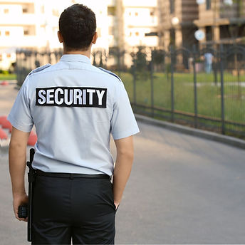Back view of security guard patrolling residential area