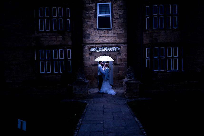 Atmospheric wedding ceremony in a grand cathedral with dramatic blue lighting and a bright glowing altar