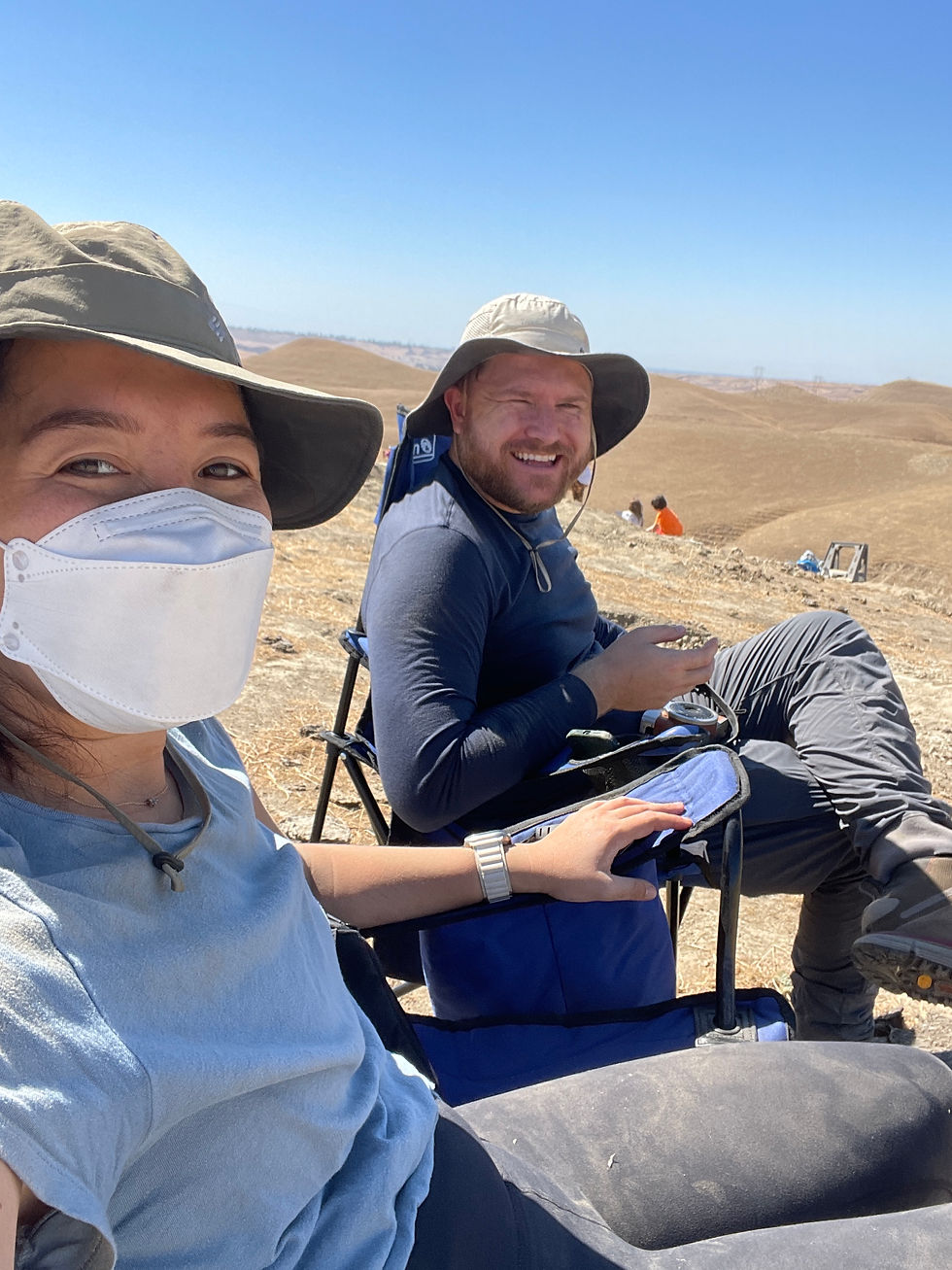 resting in folding chairs on a dig