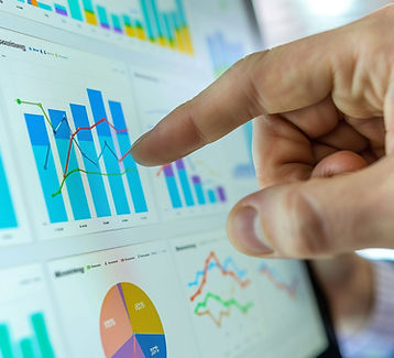 SMSCo analyst reviewing performance charts and sales data to optimize brand strategy and distribution efficiency.