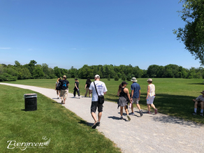 Participants walking together under a clear blue sky during the "Pass the Care Forward" event by Evergreen Hospice, honoring their loved ones.