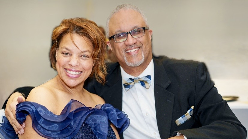 Larry and Adria smiling together at a formal event