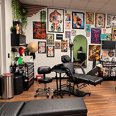 A tattoo station by the art wall on the House of Ink shop floor