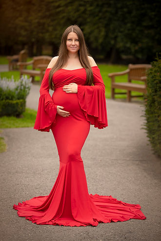 pregnant lady in a red dress standing