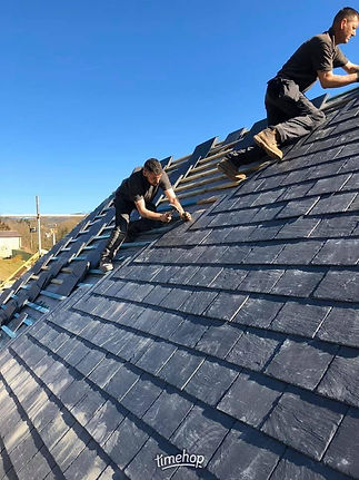 Roofers working on slate roof