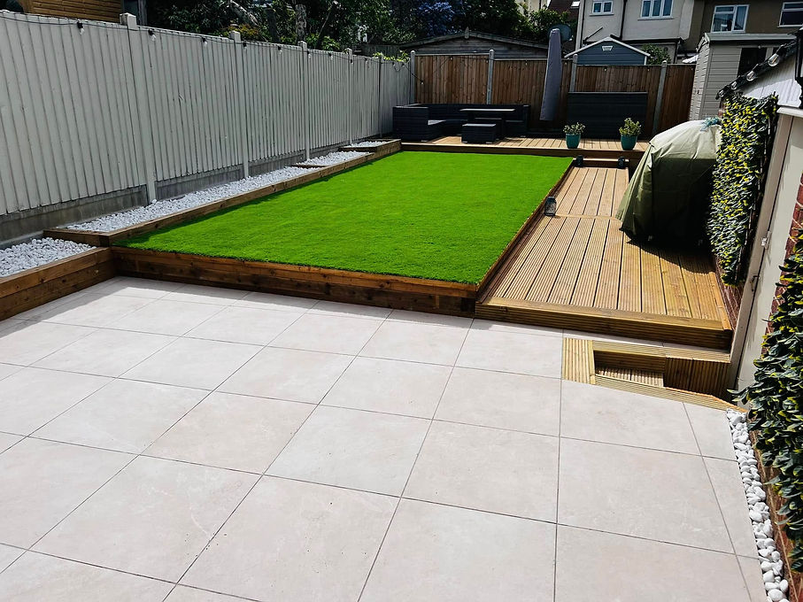 A backyard featuring a lush grass lawn and a spacious wooden deck for outdoor relaxation and gatherings