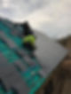 Roofers installing slate tiles