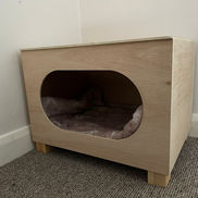 Pet bed in wooden housing