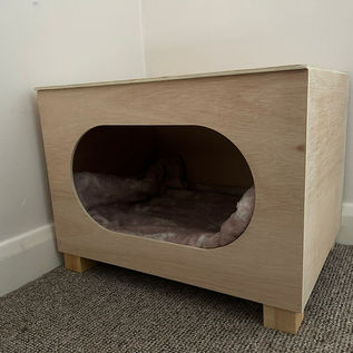 Pet bed in wooden housing