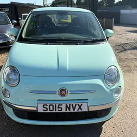 The front view of a mint green Fiat 500