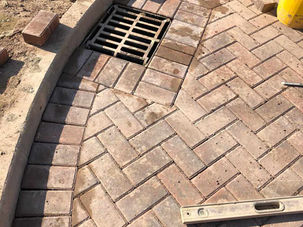 Brick paving with drainage grate