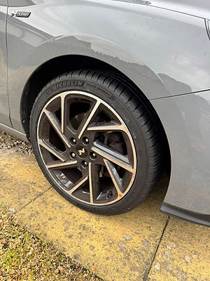 Close-up of a gray car's rear wheel