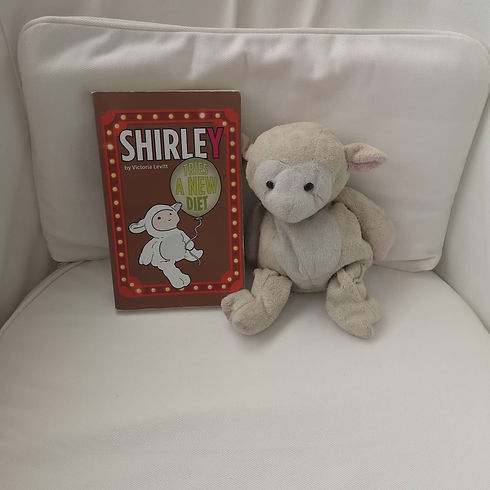 Book and stuffed animal lamb