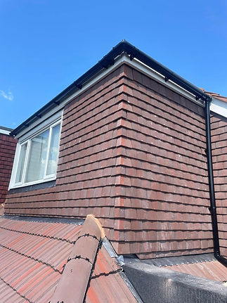Roof corner with window and tiles