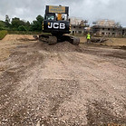 landscape after building removal with piles of sorted materials