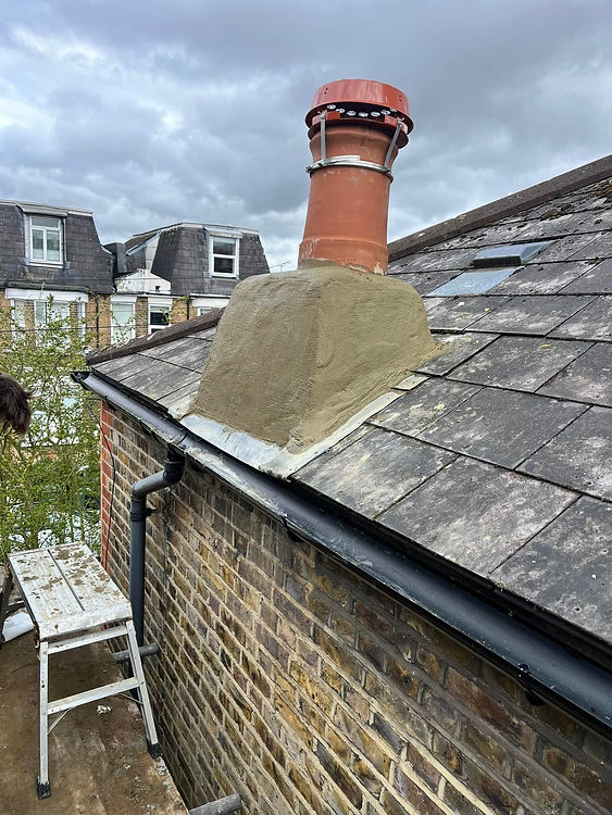 A red chimney pot atop a sloped, shingled roof