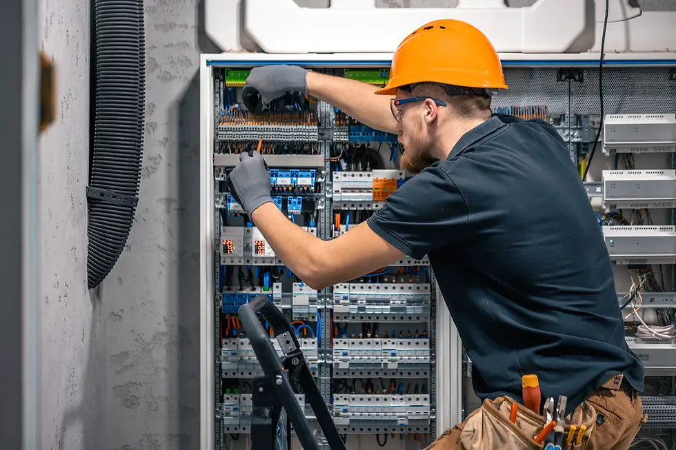 an electrician inspecting electrical control panel
