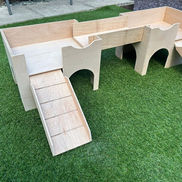 Wooden play structure on grass