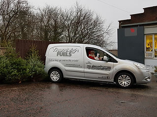 side view of a van in front of a building