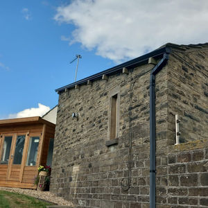 Stone cottage with a wooden extension