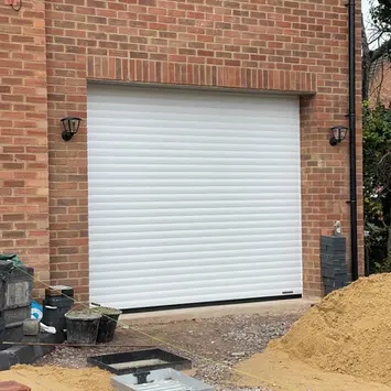 brick exterior of a house with white garage door