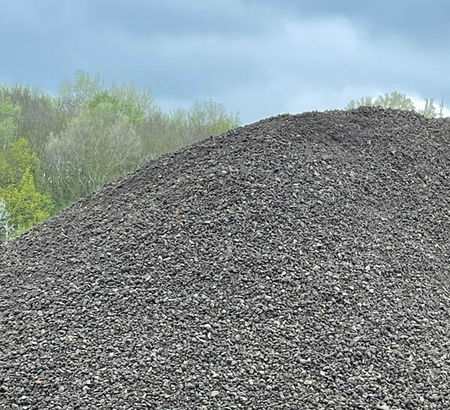 A large mound of dark gravel
