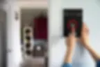 close-up image of a woman's hand while setting burglar alarm