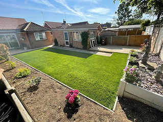 A well-maintained backyard features a lush green lawn