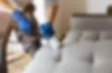 a person vacuuming sofa