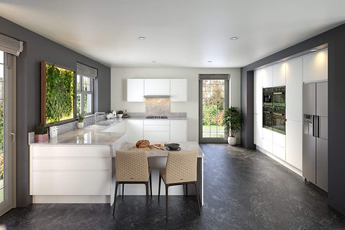Modern kitchen with white cabinets and marble countertops, featuring a small table with two beige chairs
