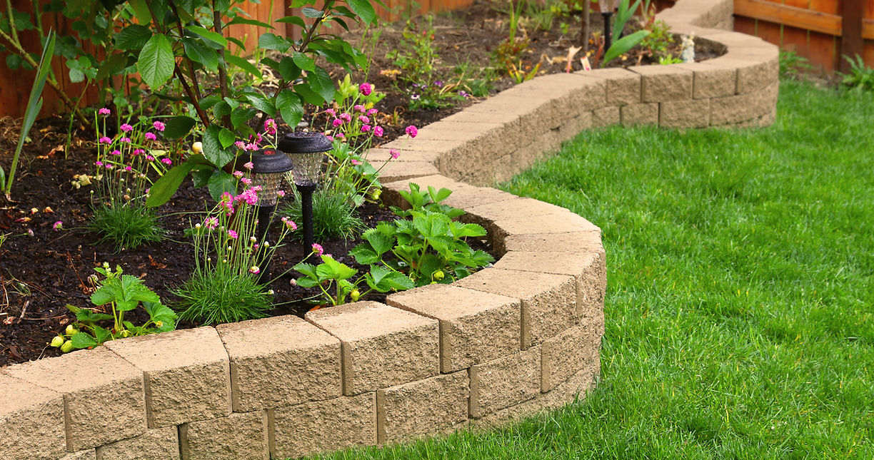stone wall with perfect grass landscaping in garden with artificial grass_edited.jpg