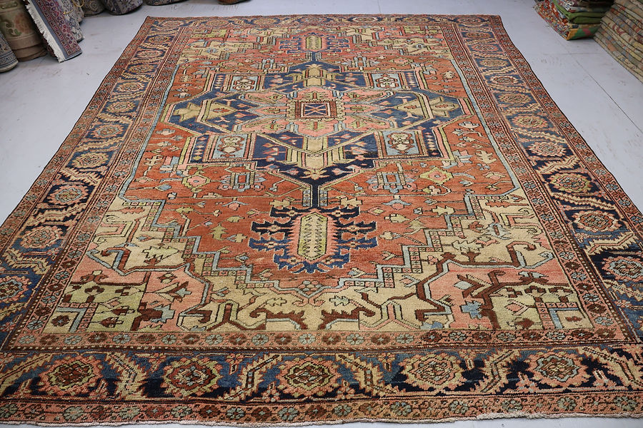 A detailed antique Persian rug with intricate geometric and floral patterns in rich colors