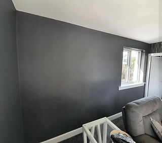 A room with a dark gray wall