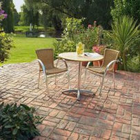 A sunny patio featuring a round table with two chairs