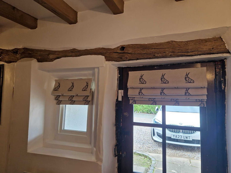 blinds on small window and door in a hare design fabric