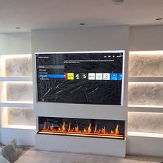 A wall-mounted television displaying a menu screen is positioned directly above a wide, linear electric fireplace