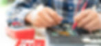 Hands of a person using multimeter while repairing laptop