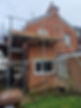 Scaffolding around a brick house