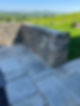 Stone wall with slate patio