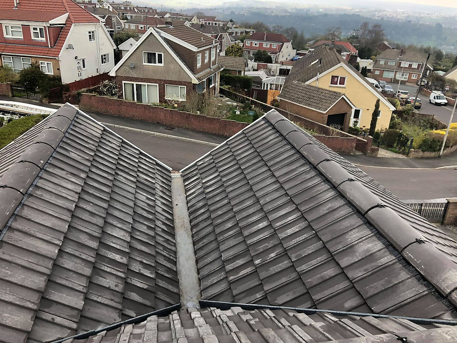 Aerial view of gray tiled rooftops showing a V-shaped valley