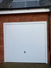 White garage door on brick wall