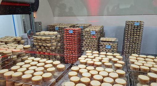Traditional Normandy cheese aging at Graindorge Cheese Factory, a highlight of our Pays d’Auge private tour featuring Camembert, Livarot and local gastronomy.