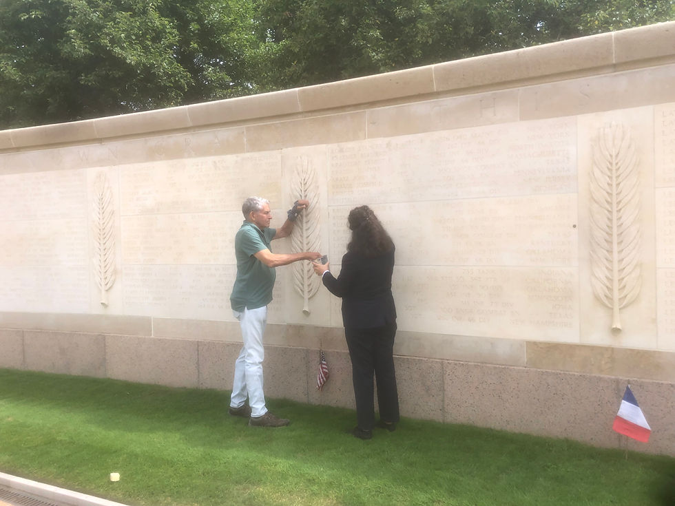 Visitor paying tribute at the Walls of the Missing at Normandy American Cemetery