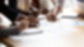 Close up of diverse business people signing papers
